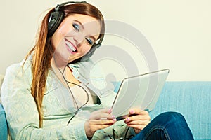 Woman with tablet headphones relaxing