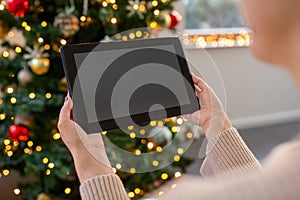 woman with tablet pc on christmas at home