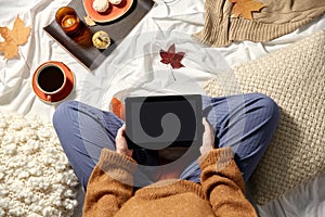 woman with tablet pc at home in autumn