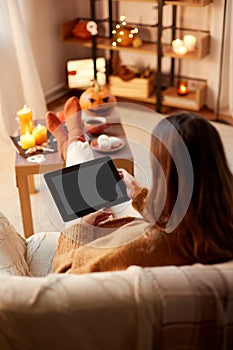 woman with tablet pc at home on halloween