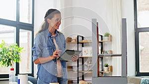 woman with tablet pc and old table for renovation