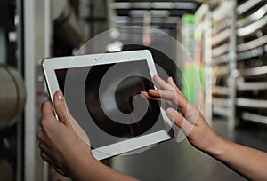 Woman with tablet in wholesale warehouse. Space for design