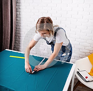 Woman tailor working with textile in her studio