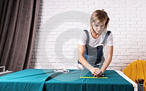 Woman tailor working with textile in her studio