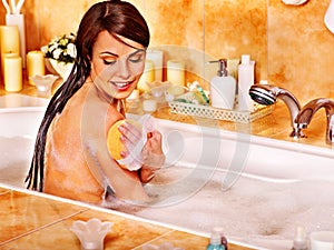 Woman take bubble bath.