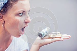 Woman take dollar from mouse trap business concept