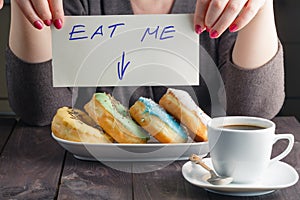 Woman take donuts and hold message eat me