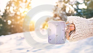 Woman take in hand cup of hot drink. Mug close up shoot