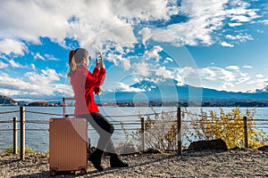 Woman take a photo at Fuji mountains. Autumn in Japan. Travel concept