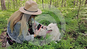 Woman take photo of her dog in the forest