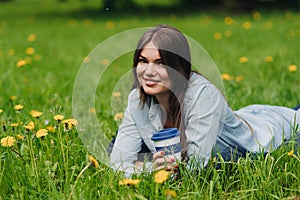 Woman with takeaway drink in park