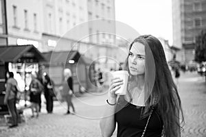 Woman with takeaway drink walk on street. Woman hold disposable coffee cup. Coffee or tea mood. Drink and food during