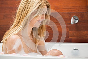 Woman takes a bath in the bathroom