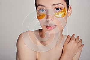 A woman takes care of delicate skin around her eyes. Cosmetic procedures