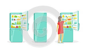 The woman takes in the fridge. Refrigerator. Products household appliances photo