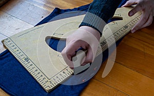 Woman takes measurements  of a blue cloth photo