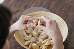 Woman takes and opens a fortune cookie