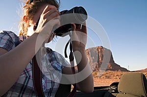 Woman takes photograph of Monument Valley
