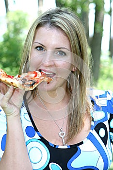 Woman taking a bite of pizza