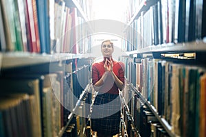 Young librarian searching books photo