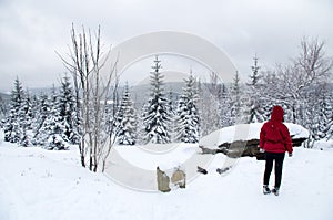 Woman taking break from cross-country skiing in Jizera Mountains