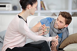 Woman taking care boyfriend with throat infection