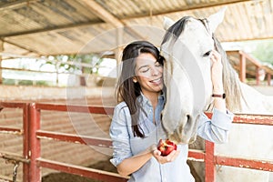 Woman Taking Care Of Horse Nutrition