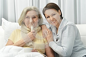 Woman taking care of ill woman