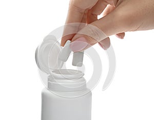 Woman taking chewing gum pieces from jar on white background, closeup