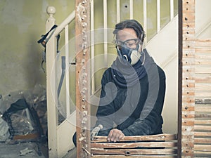 Woman taking down wattle and daub wall