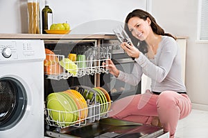 Woman Taking Drinking Glass From Dishwasher