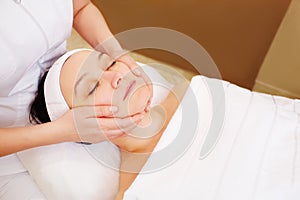 Woman taking facial treatments at beauty spa