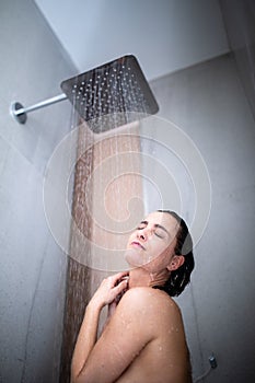 Woman taking a long hot shower washing her hair