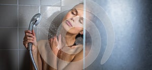 Woman taking a long hot shower washing her hair