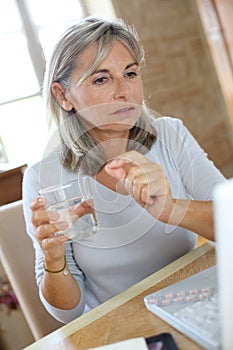 Woman taking medicament with help of internet