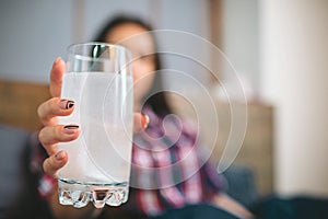 Woman taking medication.