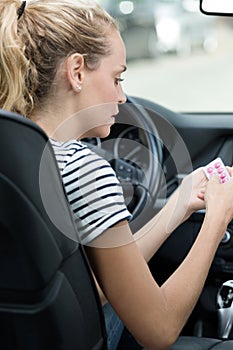 Woman taking medication while driving
