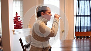 Woman taking medication with water