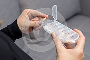 Woman taking medication. Woman takes pills from box. Healthcare concept with medicines