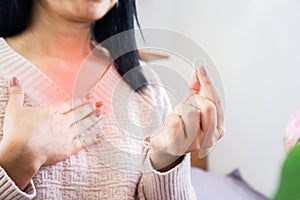 Woman taking medicine for GERD, having problem with heartburn from acid reflux disease, discomfort caused by stomach bloating