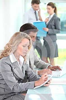Woman taking notes in a meeting