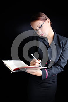 Woman Taking Notes While Talking on Phone