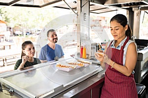 Woman taking orders in a food truck