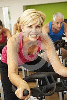 Woman Taking Part In Spinning Class In Gym