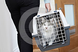 Woman Taking Pet Cat To Vet In Carrier