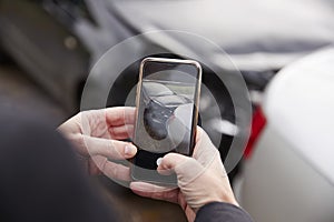 Woman Taking Photo Of Car Accident On Mobile Phone