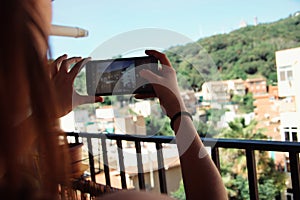 Woman taking a photo with her cellphone.