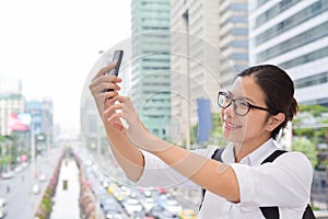 Woman taking photo with her smart phone.