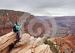 Woman Taking Photo At Ooh Aah Point In The Grand Canyon