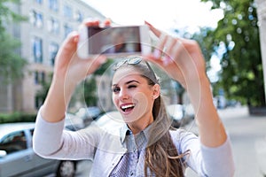 Woman taking photo outside